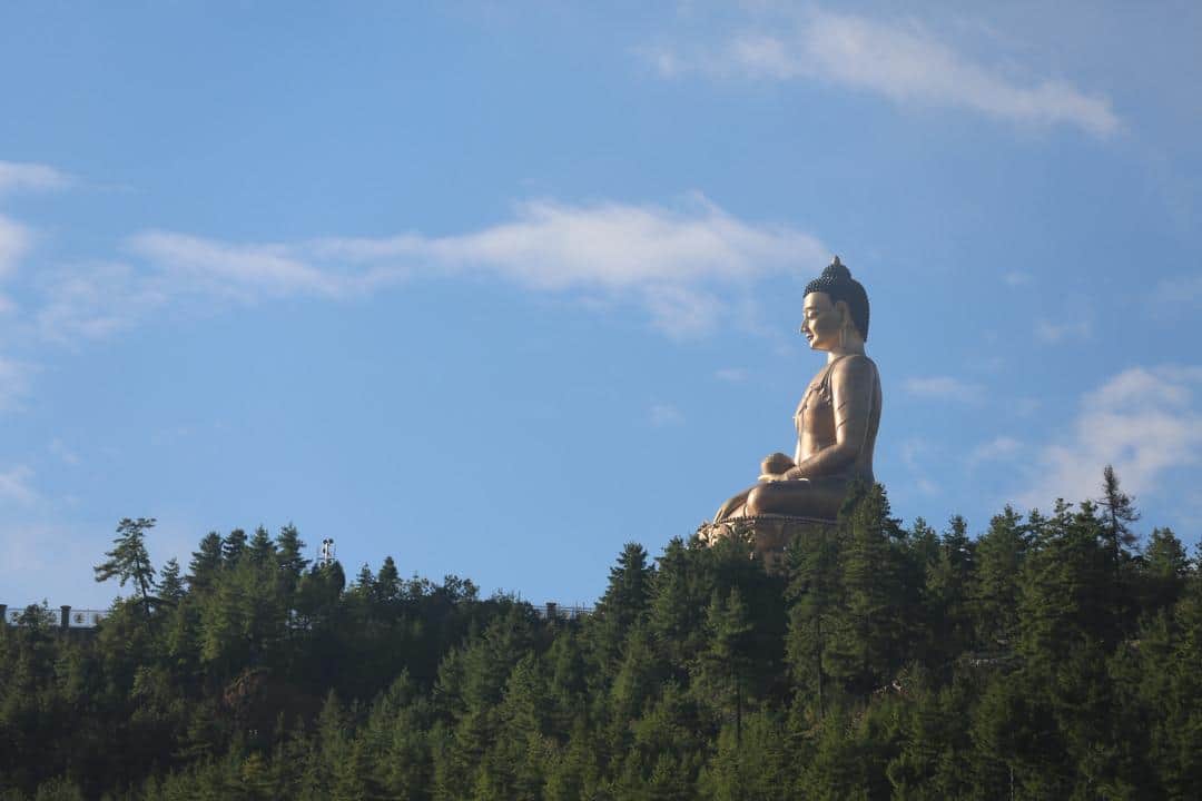 Buddha Dordenma illuminated at dusk during evening prayer